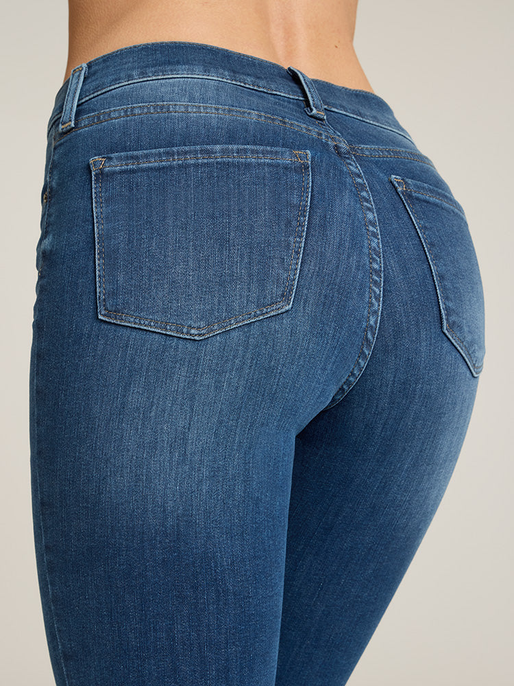 Women wearing Medium Blue High Rise Miniboot Ankle Logan Jeans
